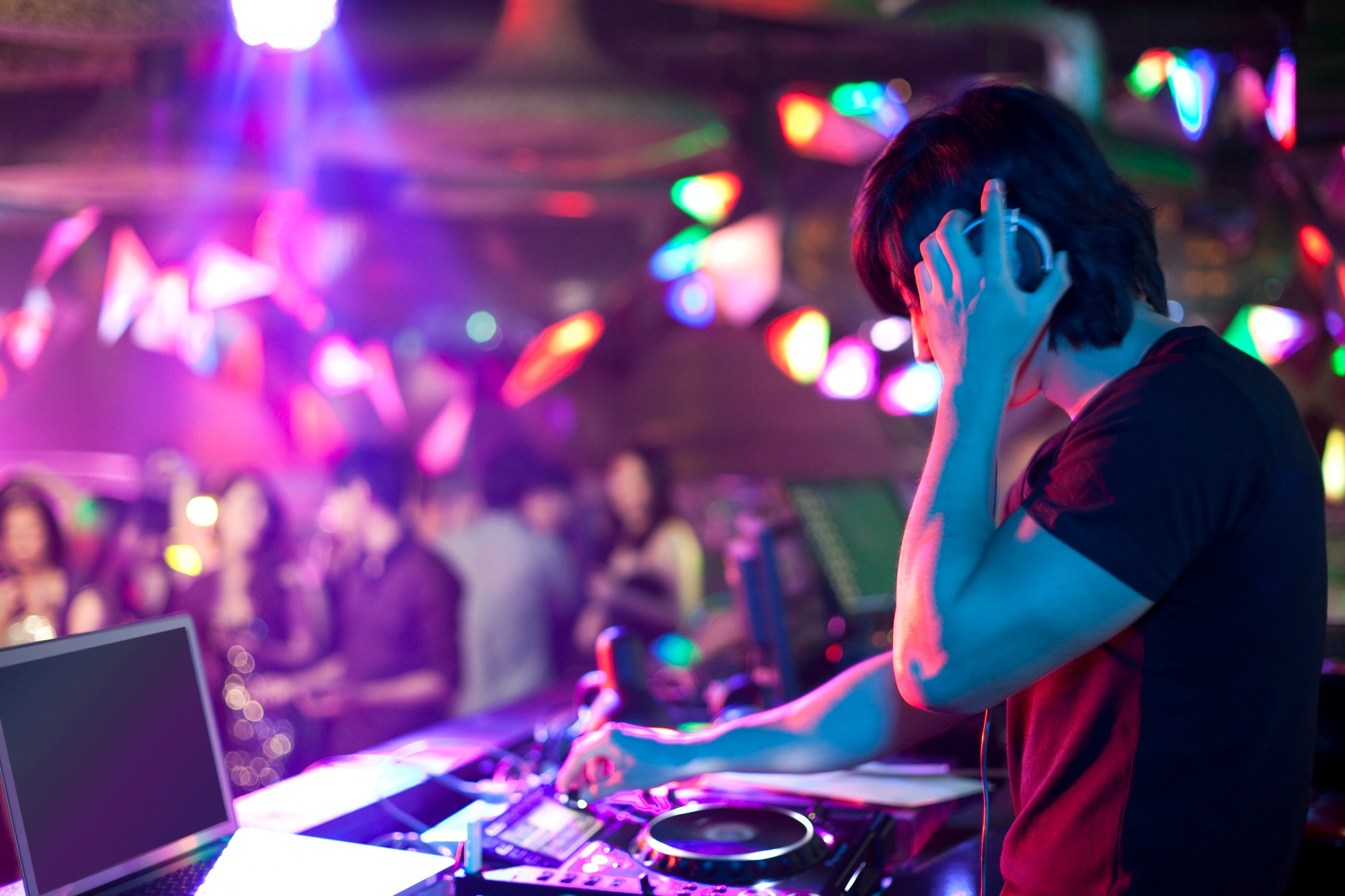 DJ doing record Scratching in nightclub